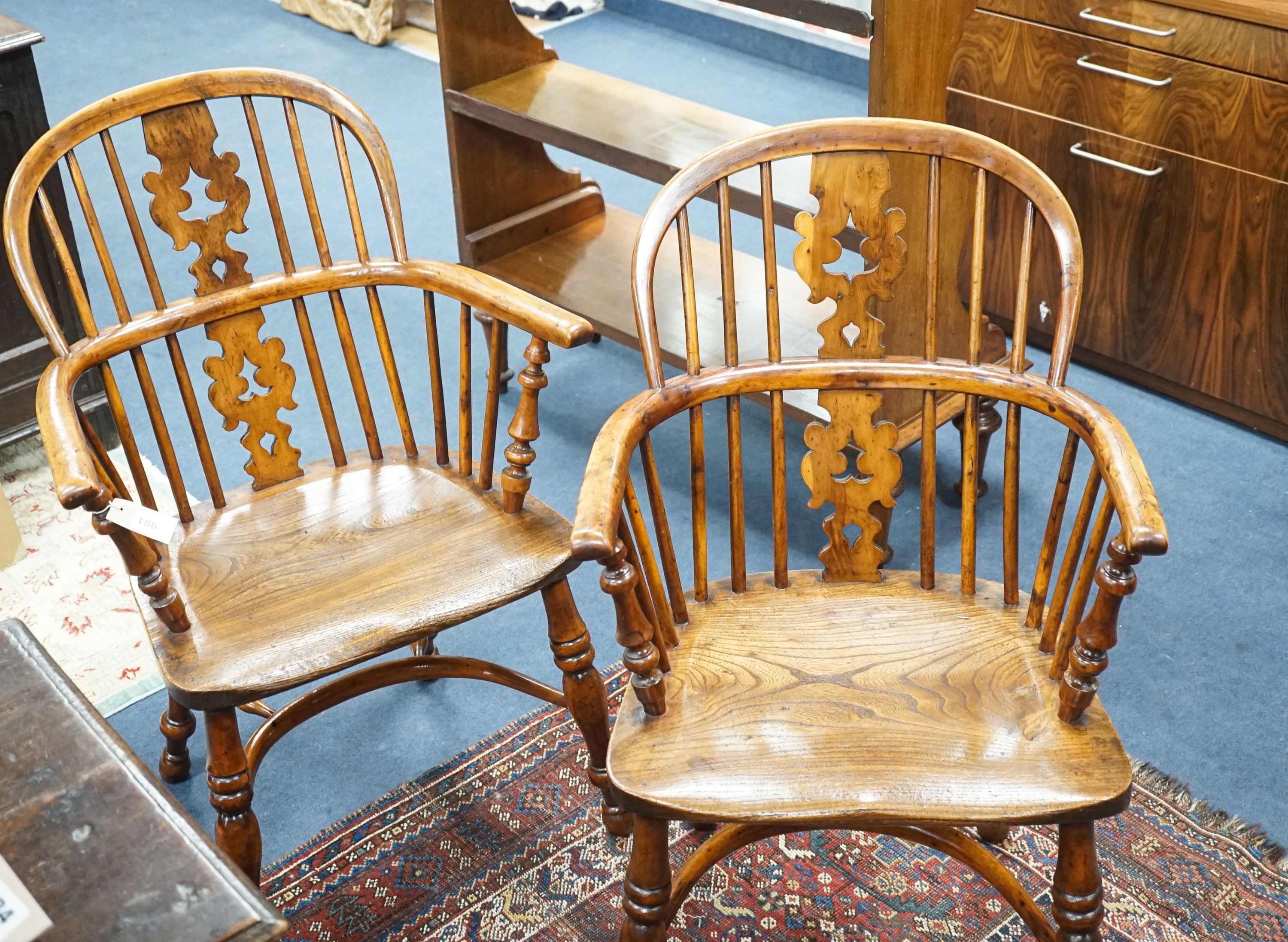 A pair of 19th century Yorkshire area yew and elm Windsor elbow chairs with crinoline stretchers, width 61cm, depth 40cm, height 95cm